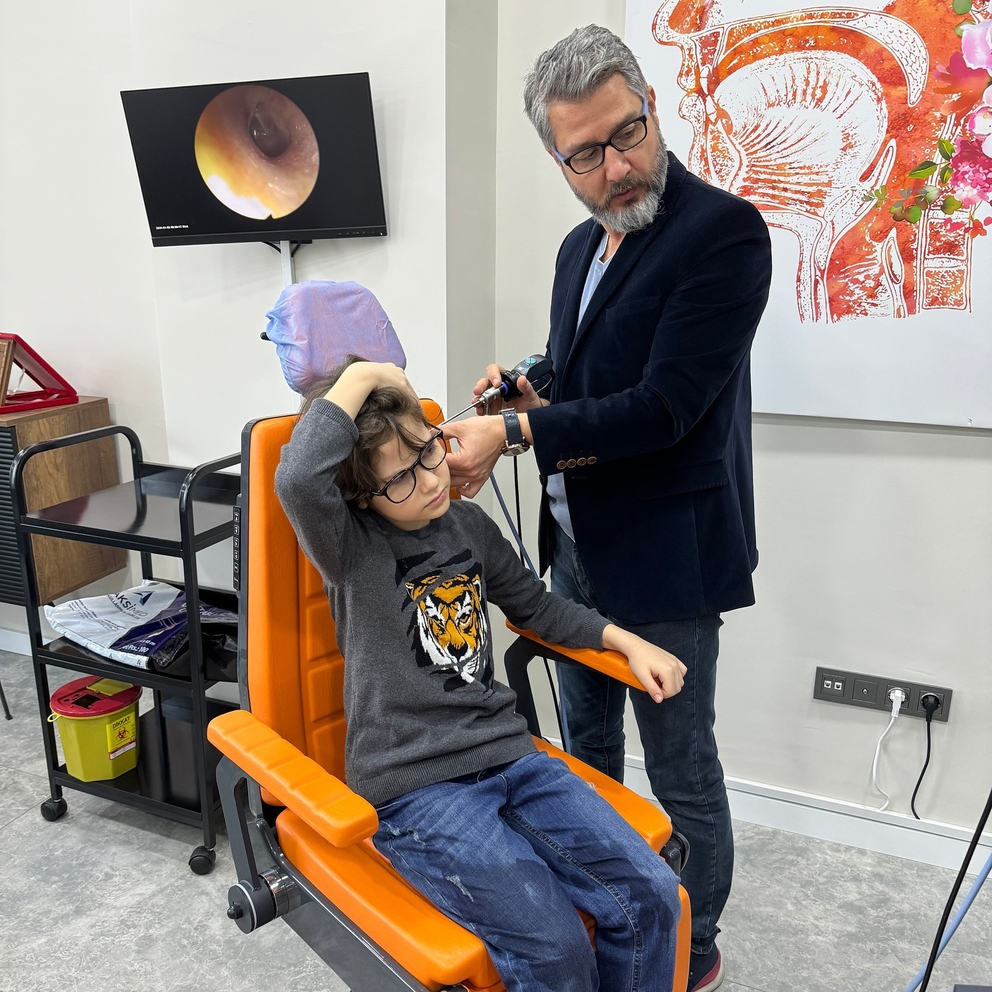 Prof. Dr. Karakoç performing an endoscopic examination on a young patient